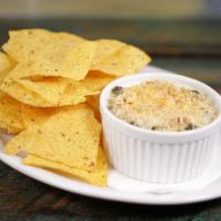 Spinach and Artichoke Dip · A traditional creamy dip, topped with Parmesan cheese and served with tortilla chips.
