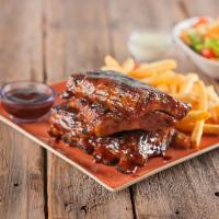 BBQ Ribs · Fork tender baby back ribs seasoned and basted with signature BBQ sauce served with French f...