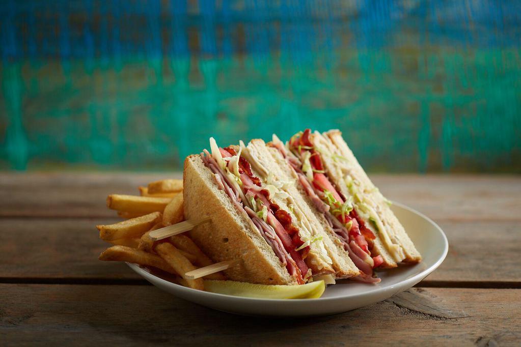 Beach Club · Sliced roasted turkey and ham, Swiss cheese, applewood-smoked bacon, lettuce, tomatoes and Hellmann's real mayonnaise on toasted country white bread.