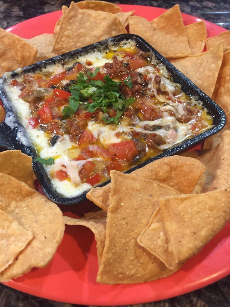 Queso Fundido · Mix of cheeses, with chorizo. Served with chips. Gluten-free preparation is available upon request.