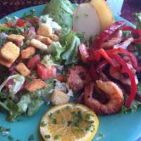 Filete de Pescado a la Plancha · TIlapia filet grilled with bell peppers, onions, and mushrooms. Served with a small salad, r...