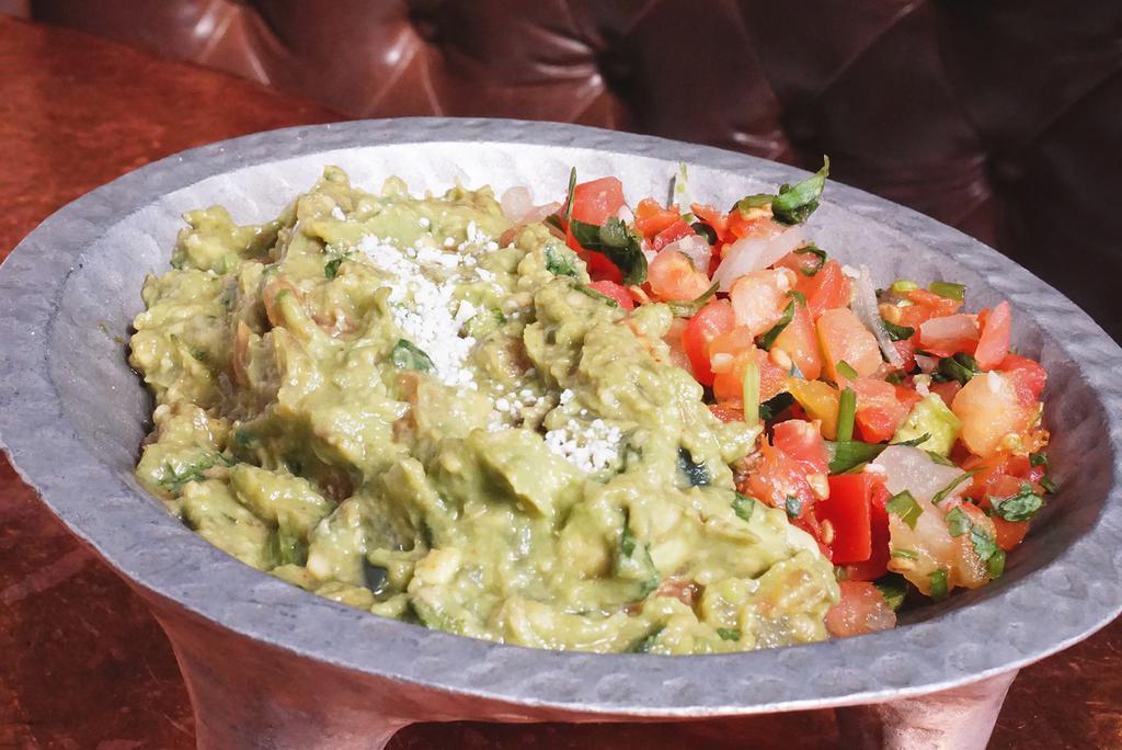 Guacamole Dip · Perfected recipe made with ripe avocados, lime, cilantro,  tomatoes, onions, jalapenos and cotija cheese.
