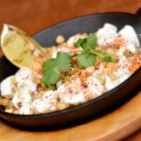 Mexican Grilled Corn · Mexican street corn, grilled with cotija cheese, c itream, Chile spice and cilantro.