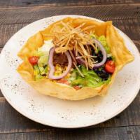 Asada Taco Salad · The classic with grilled carne asada steak, black beans, corn, tomatoes, tortilla strips, gu...