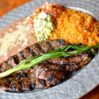 Carne Asada · Skirt steak seasoned with our proprietary spices. Served with rice, beans, pico de gallo, an...
