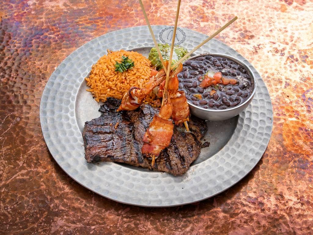 Surf and Turf Asada · Over 1/2 lb. of top grade skirt steak paired with bacon-wrapped succulent prawns. with pico de gallo, and tortillas.