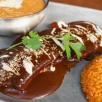 Mole Poblano · Grilled chicken breast, mole sauce made with Chile, nuts and chocolate. rice, beans and tort...