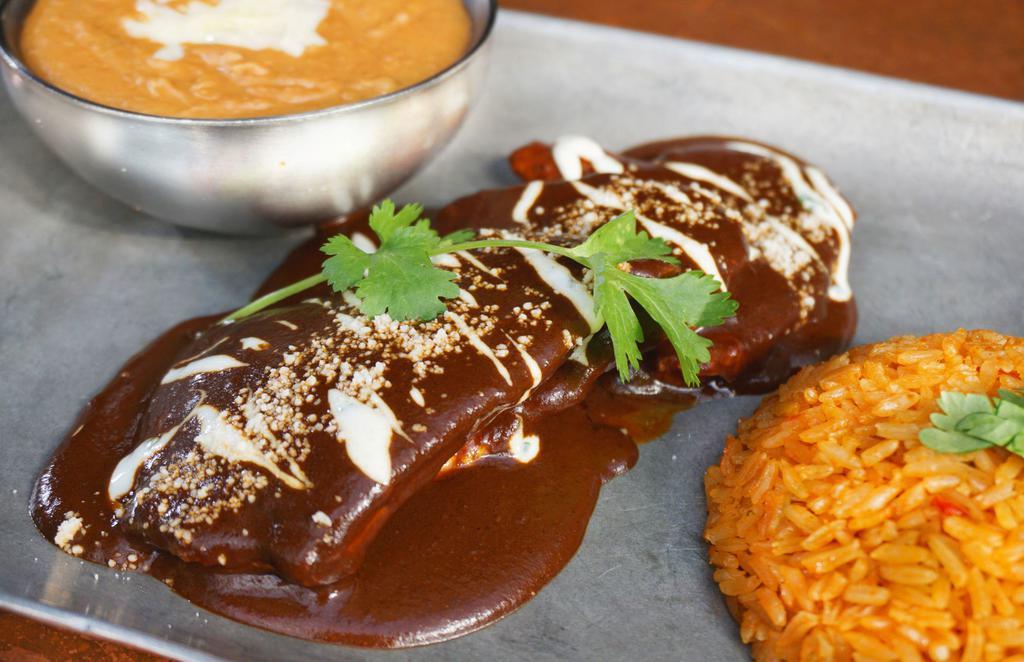 Mole Poblano · Grilled chicken breast, mole sauce made with Chile, nuts and chocolate. rice, beans and tortillas. Contains peanuts.
