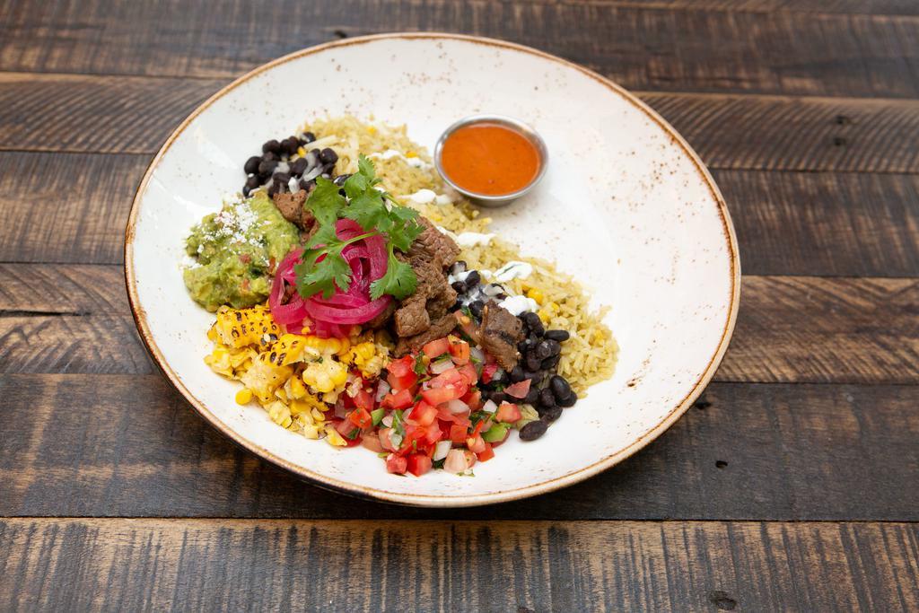 Gourmet Parrilla Bowl · Mexican rice bowl with cilantro lime rice, black beans, cheese, pico de gallo, crema, red onion escabeche and salsa roja.