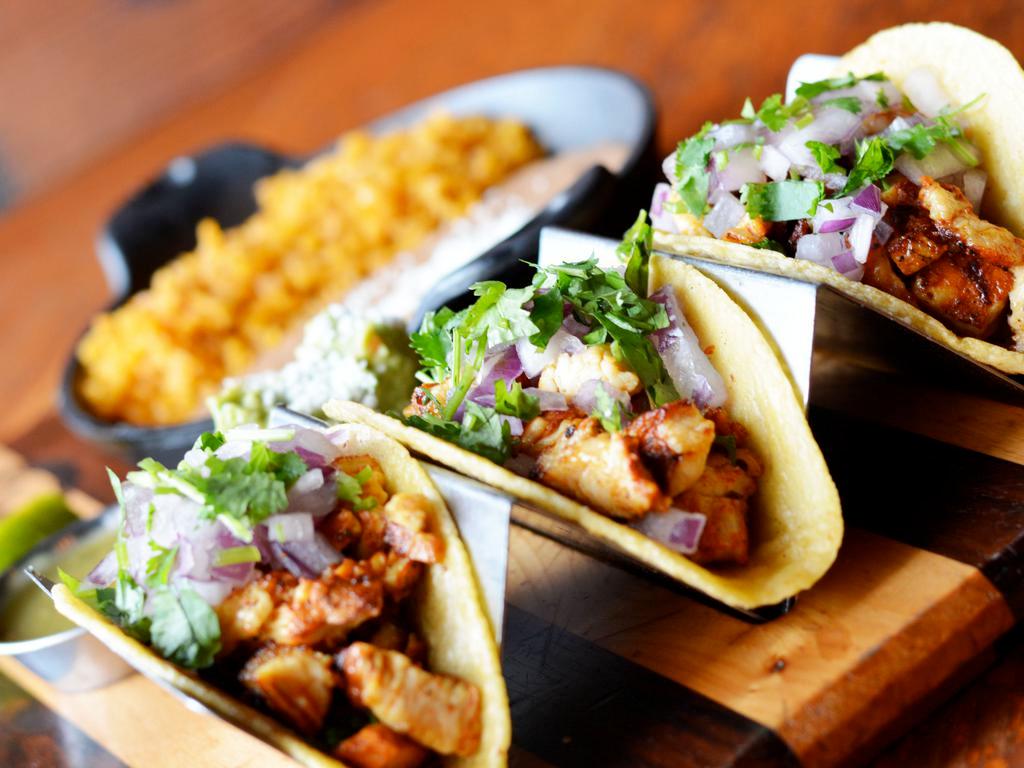 Mexico City Tacos · Cilantro, red onions, tomatillo salsa and lime. Gluten free with corn tortilla.