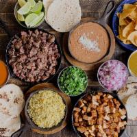 Authentic Mexico City Taco Bar · Complete authentic taco bar with all of the fixings! Barbacoa shredded beef and grilled Achi...