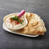 Hummus · Chickpeas mixed with garlic and lemon and tahina. Served with pita bread. 