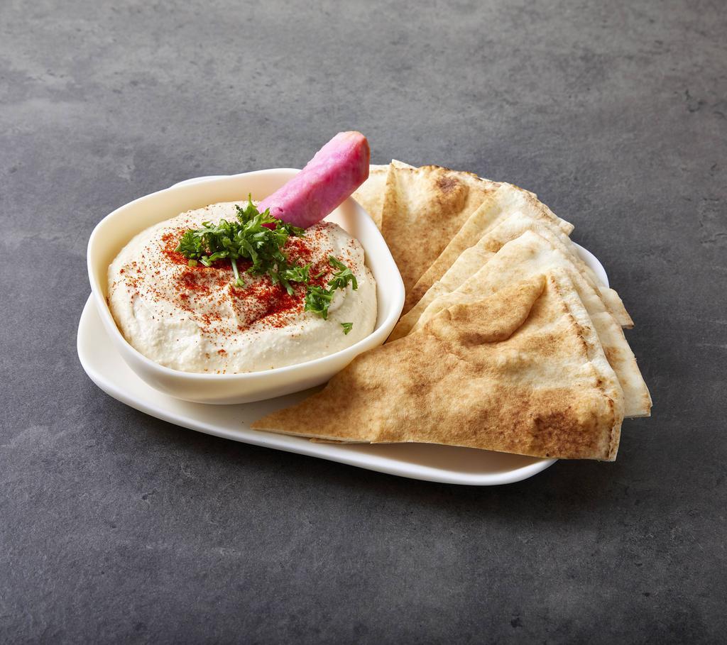 Hummus · Chickpeas mixed with garlic and lemon and tahina. Served with pita bread. 