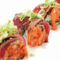 Red Devil Roll · Sliced of spicy Cajun tuna on top of very spicy chopped tuna, salmon and white tuna with che...