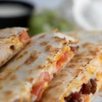 Quesadillas · Large flour tortilla melted cheddar and pepper jack cheese and served with pico, sour cream ...