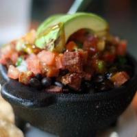 Chifrijo Fiesta Tray · An authentic starter to your meal. Fried pork is layered with whole black beans, white rice,...