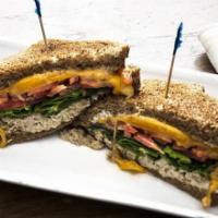 Tuna Melt · Specialty Tuna, tomato, spinach, melted cheddar cheese, and mayonnaise on toasted wheat bread.