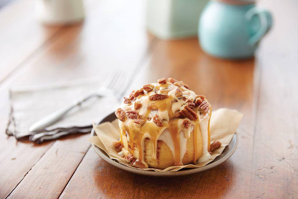 Caramel PecanBon® · Warm dough, legendary Makara® Cinnamon, topped with caramel frosting, and pecans. Add this caramel twist to our Classic Roll or MiniBon®.