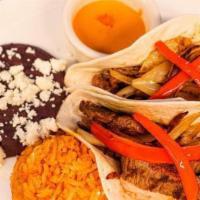 Tacos al Carbon · Grilled steak or chicken tacos topped with batter onions. Served with Mexican rice, refried ...