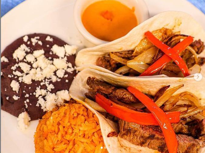 Tacos al Carbon · Grilled steak or chicken tacos topped with batter onions. Served with Mexican rice, refried beans, guacamole, and salsa molcajete.