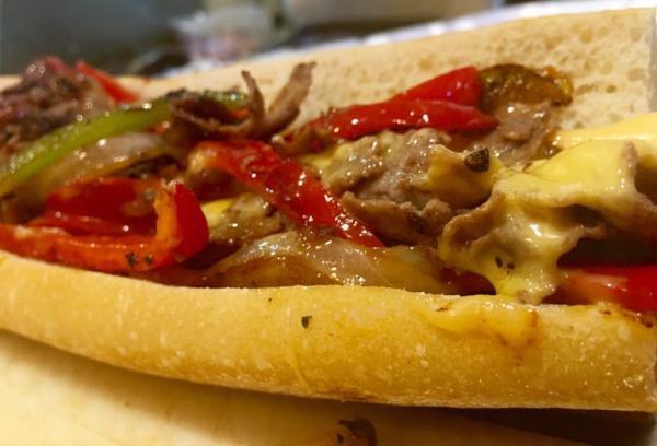 Philly Steak Sandwich  · with cheese, peppers, and onions Served with french fries. 