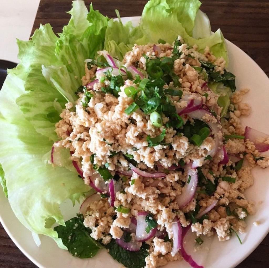 Larb Salad ( Chicken ) · Minced chicken mixed with red onion, cilantro, mint, rice powder, scallions, and chili, tossed in lime sauce and served with cabbage.