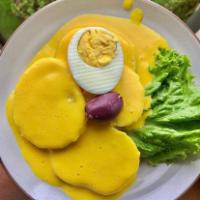 Papa a la Huancaina · Boiled potatoes covered with a Peruvian yellow pepper sauce made with cheese and served with...