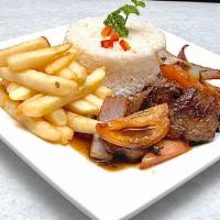 Lomo Saltado · Beef stir fried sauteed with onions, tomatoes with French fries and rice.