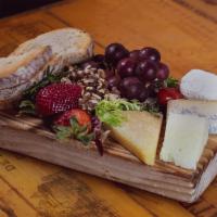 Plateau de Fromage  · Assortment of cheeses.  Served with red grapes, walnuts, and Bushwick bakery bread. 