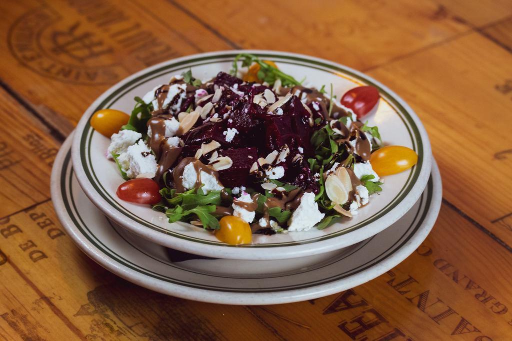 Salade D’ Arugula Et Montchevre  · Arugula, roasted beets, goat cheese, toasted almonds served with balsamic dressing. 