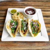 Lunch Tacos De Carnitas · 3 tacos with shredded pork and cilantro. Served with Mexican rice and black beans. Choice of...