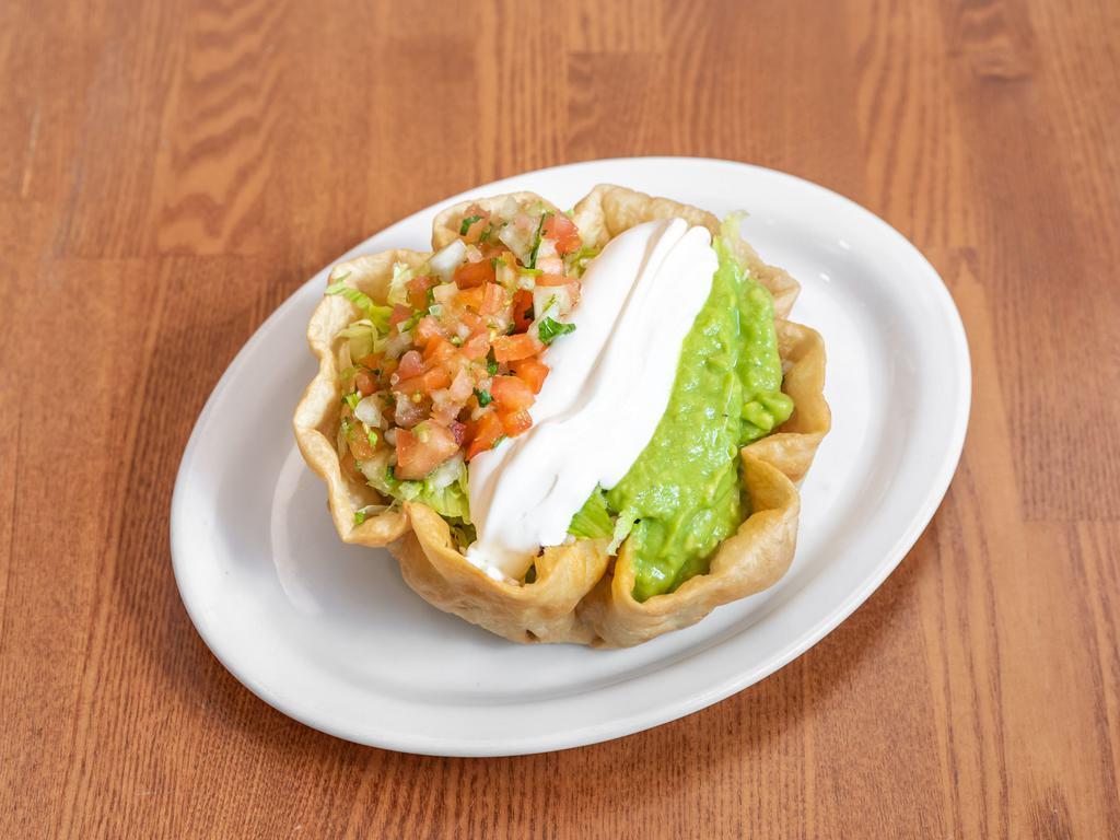 Taco Salad · Rice, beans, cheese, sour cream, lettuce, guacamole, and Mexican salsa.