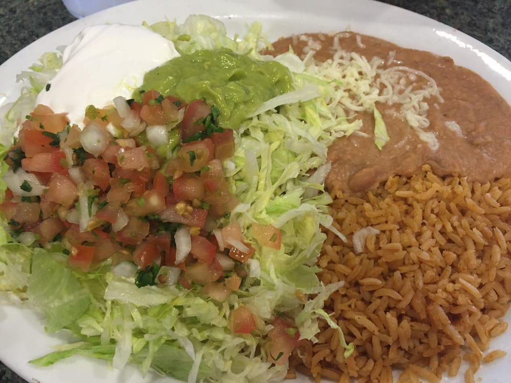 Tostada Plate · Lettuce, guacamole, sour cream, Mexican salsa and cheese.