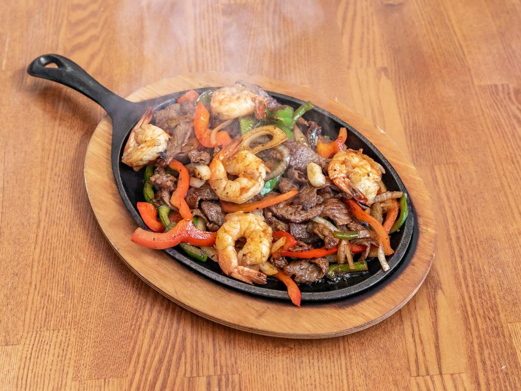 Fajitas Mixtas · Beef and shrimp. With fajita vegetables. Side of rice, beans, lettuce, sour cream and guacamole.