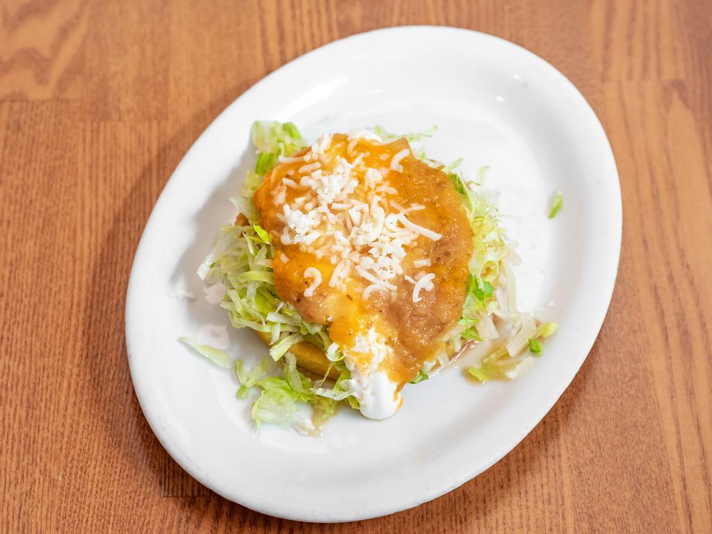 Sopes · A thick and consistent fried corn tortilla with beans, lettuce, sour cream, cheese, salsa and meat of your choice.