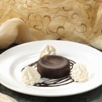 Gluten Free Chocolate  Cake · A rich and decadent flourless cake topped with chocolate ganache. Served with whipped cream