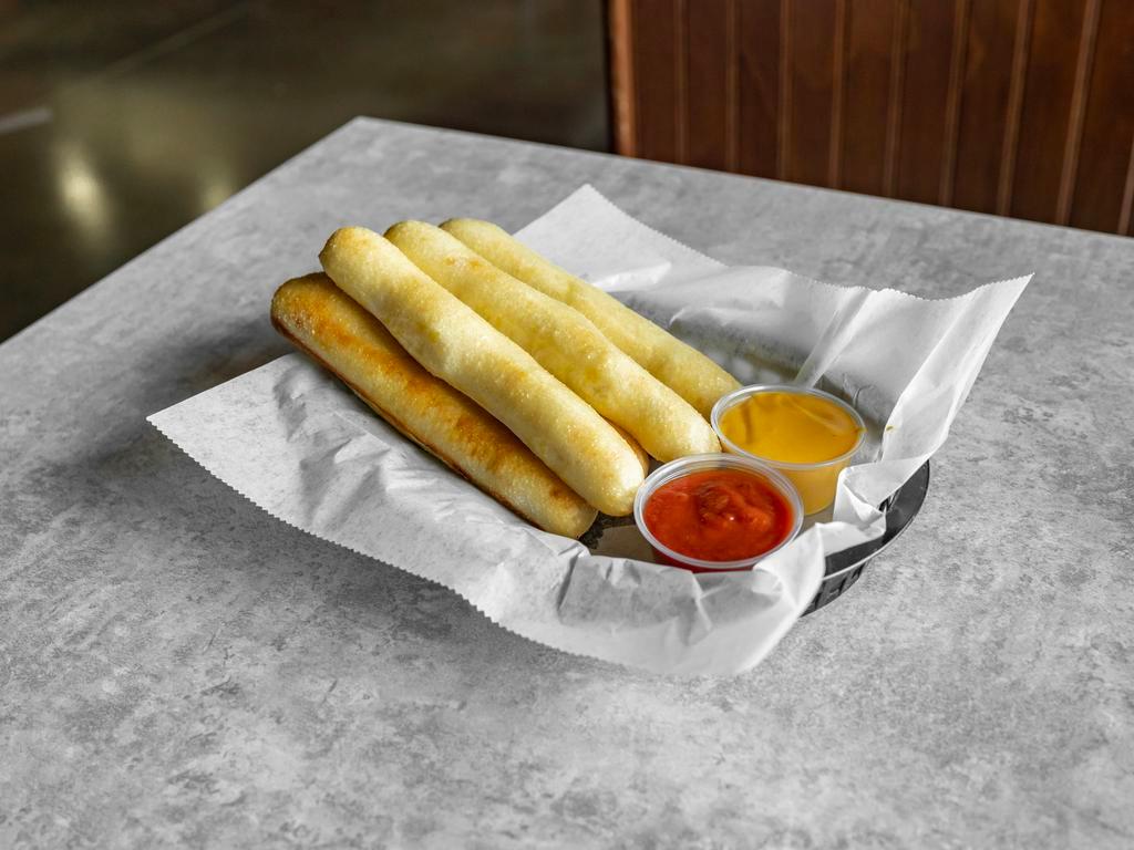 Full Order of Fresh Baked Breadsticks Choice · Our breadsticks are made fresh every day, hand-rolled, lightly salted, and baked to a golden-brown served with a choice of red sauce, cheddar cheese, nacho cheese, or garlic butter.