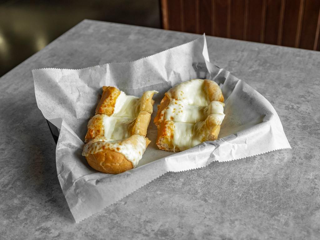Garlic Cheese Bread · A full loaf of Italian bread brushed with butter, covered with garlic salt, and baked with mozzarella cheese.