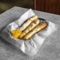 Pepperoni Sticks · Three fresh-baked breadsticks stuffed with pepperoni and cheese served with a choice of red ...