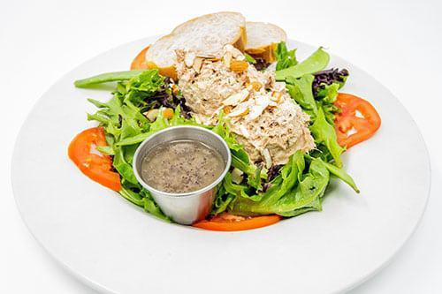 Tuna Salad Salad · Our house made Tuna salad served with tomatoes and snow peas on a bed of fresh mixed greens and topped with sliced almonds.