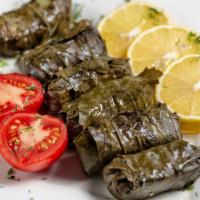 Dolma with Sour Cream · Stuffed grape leaves with ground meat.