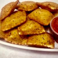 Breaded Cheese Ravioli · Ricotta cheese stuffed ravioli rolled in bread crumbs and toasted to a golden brown.