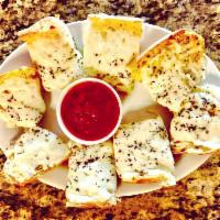 Cheese Garlic Bread · Toasted homemade cheese garlic bread served with a side of marinara.