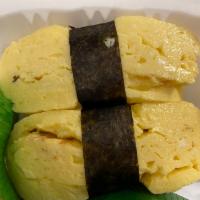 Tamago Nigiri  · Sushi laid top of rice.