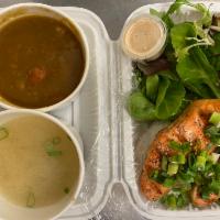 Curry Salmon Over Rice Plate · Grilled salmon with curry, miso soup and green salad.