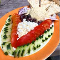 Hummus · House made and served with tomatoes, cucumber, red onion, feta, Kalamata olives dressed in r...