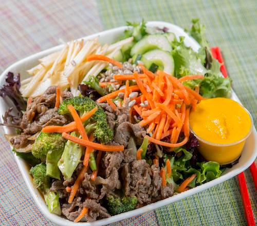Beef Salad · Mixed greens topped with thinly sliced apples, carrots, pickled cucumbers, sunflower seeds, and a side of beef. All salads are served with house dressing.