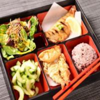 Mackerel Bento · Grilled mackerel is served with a scoop of rice, side salad, cucumber salad, 2 potstickers, ...