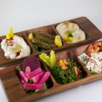 Mezza Medley · Hummus, baba ghannouj, feta cheese, grape leaves, pickles and tabouleh & pita. Vegetarian.