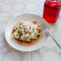 Sope de Chorizo con Papas · Mexican sausage with potatoes sope. Corn. Served with beans, lettuce, tomato, sour cream and...